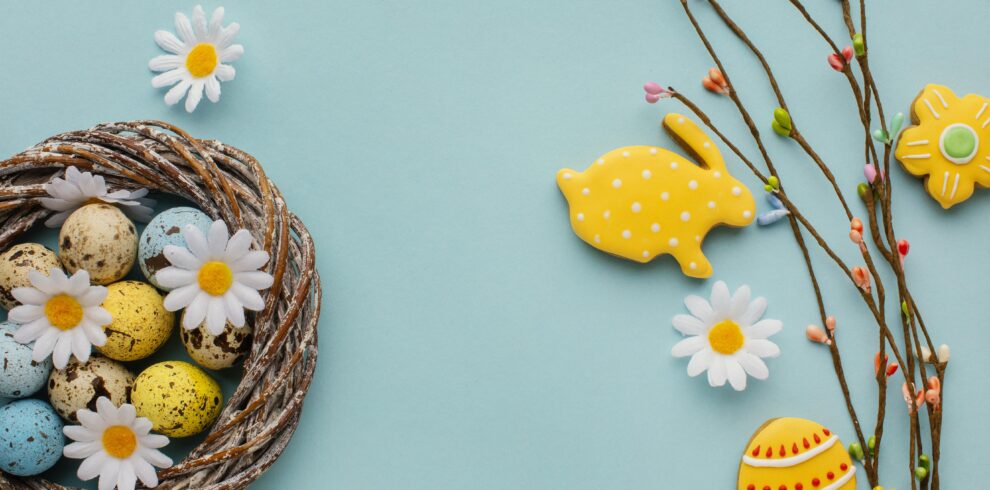 top view easter eggs basket with chamomile flowers